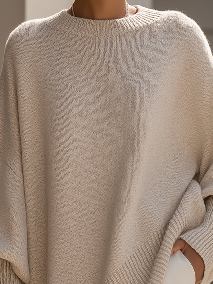Oversized knit sweater styled over slim denim