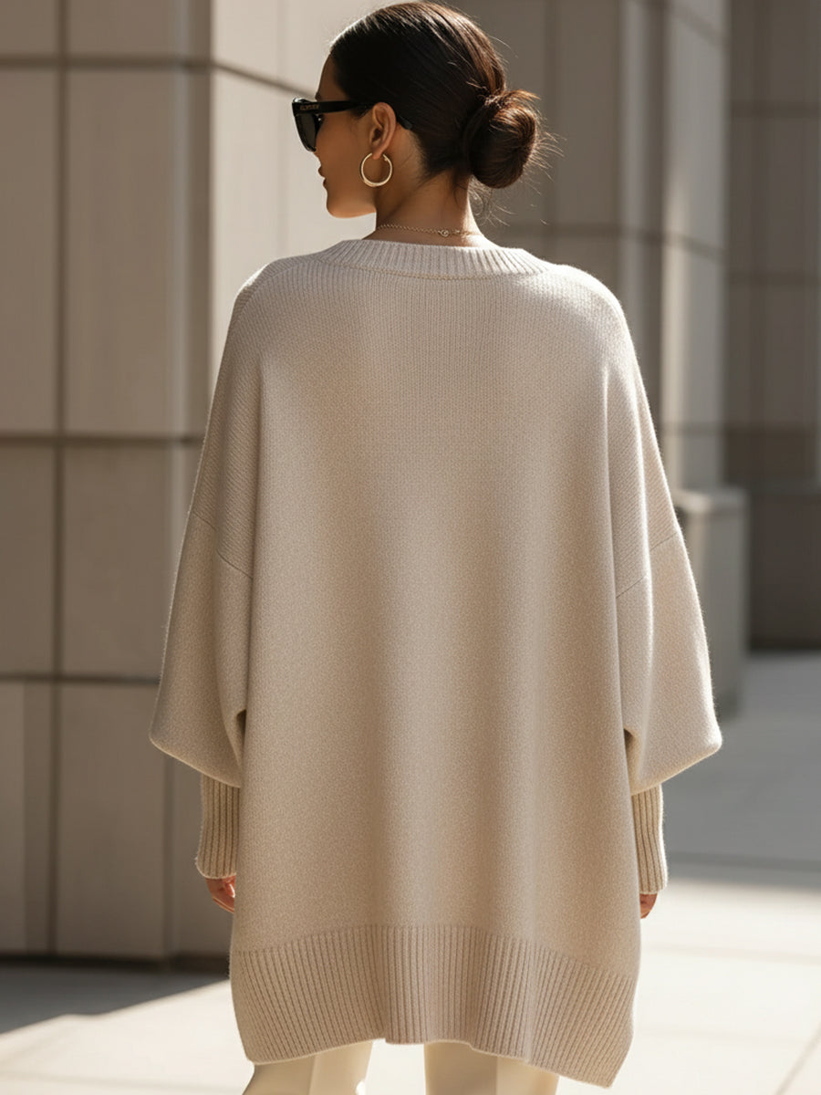 Oversized knit sweater, side view showing the loose drape at the arms