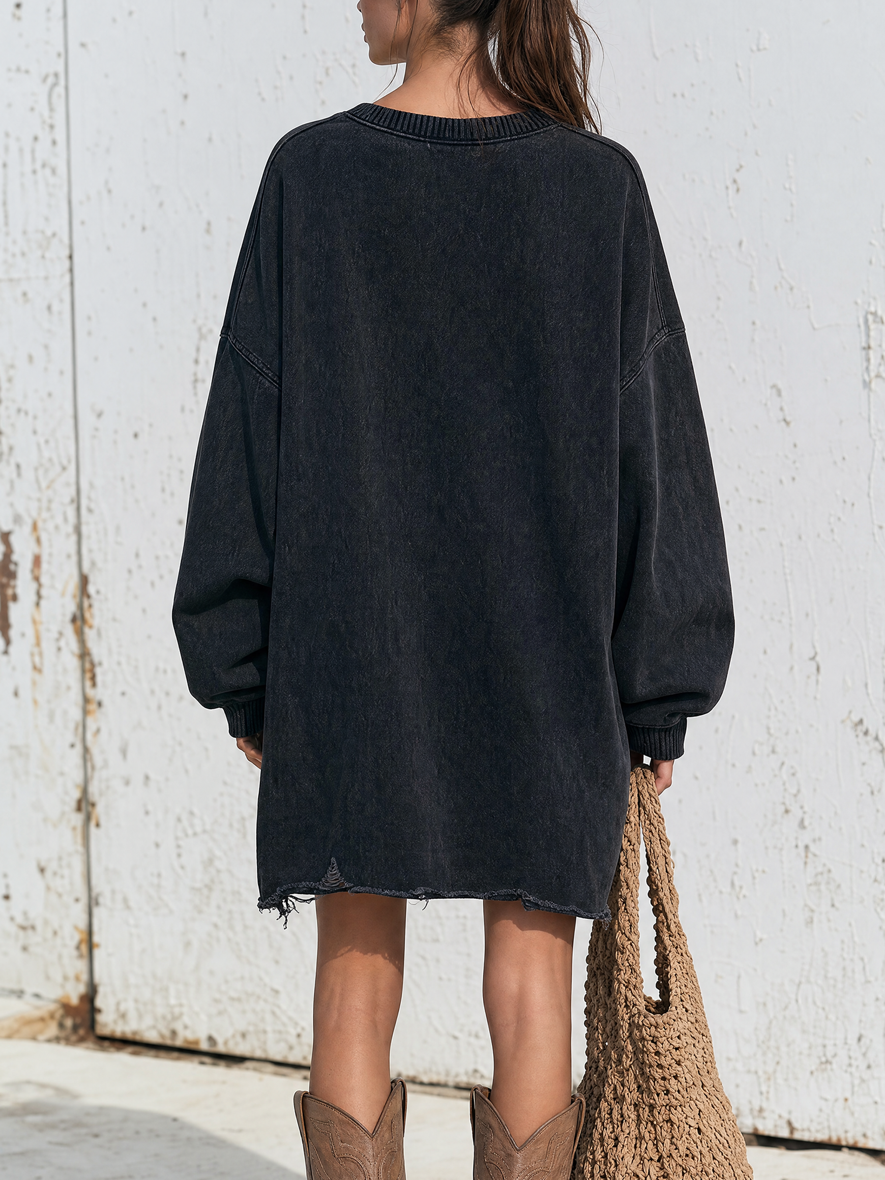 Ripped and distressed hem detail of the sweatshirt dress