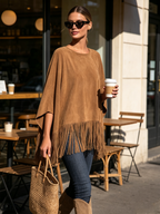 Tassel fringe trim detail along the poncho hem