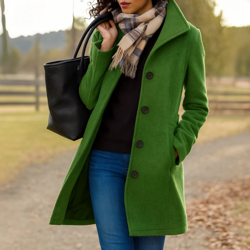 Long coat for women worn buttoned over a sweater, showing the straight knee-length cut