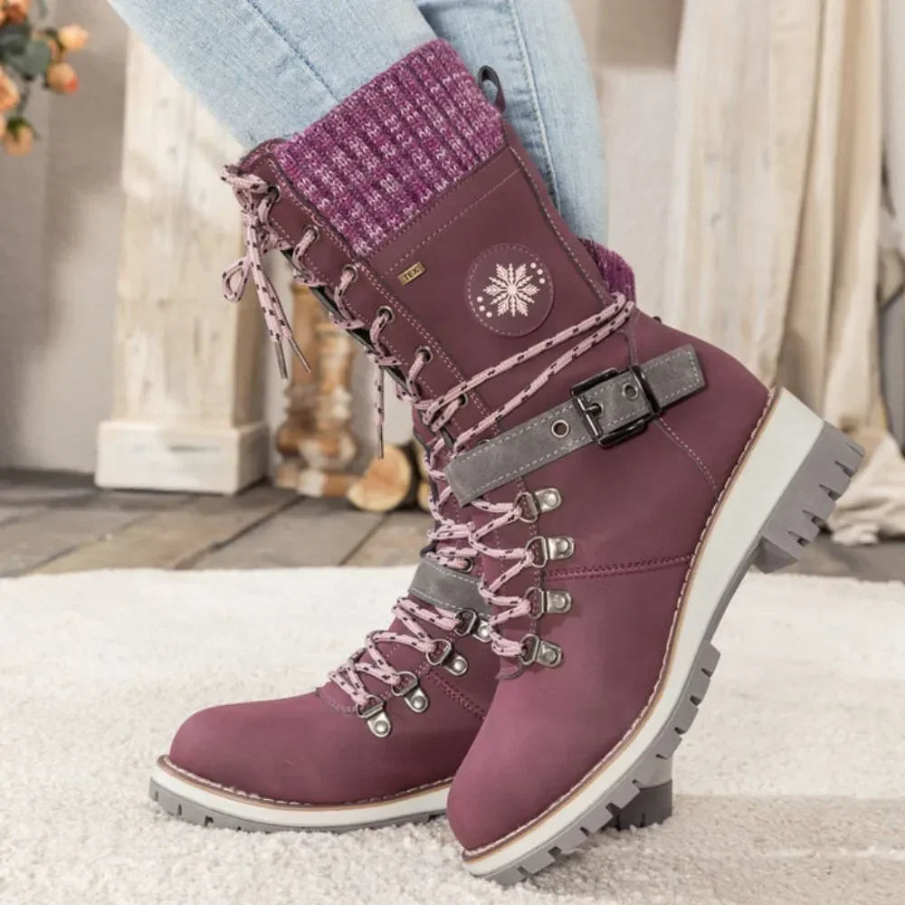 Purple winter boot for women shown on a plain backdrop