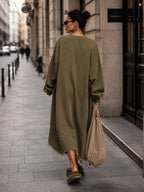Close view of the raw hem and ribbed cuff on the olive dress