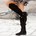 Black suede knee high boots for women with a slouched shaft, side view