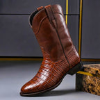 Cognac brown leather boot in profile, stitching visible along the welt
