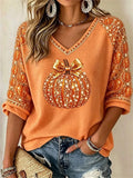 Orange pumpkin print Halloween blouse with V neckline and bow detail