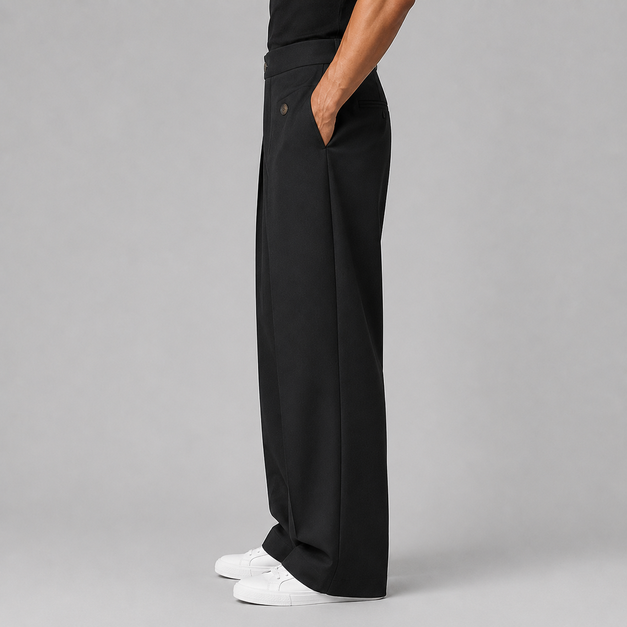 Men's wide leg pleated trousers, detail of the front pleats and waistband