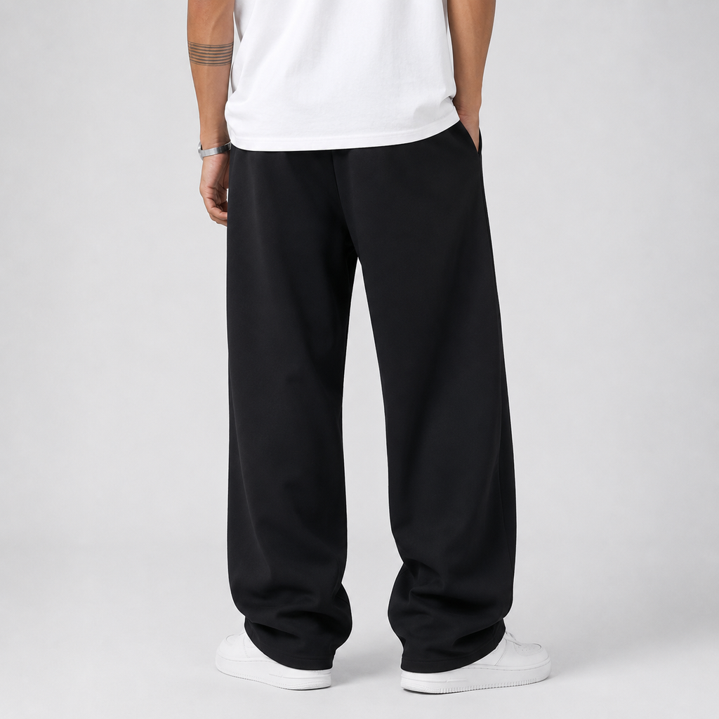 Men's thick knit joggers worn with a tee, side view showing the drape