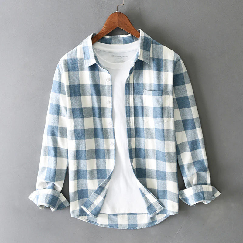 Blue plaid shirt buttoned through, chest pocket on the left