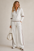White quarter zip knit set worn with wide leg trousers