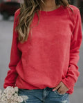 Crewneck sweatshirt for women in red, showing the ribbed neckband and raglan sleeves