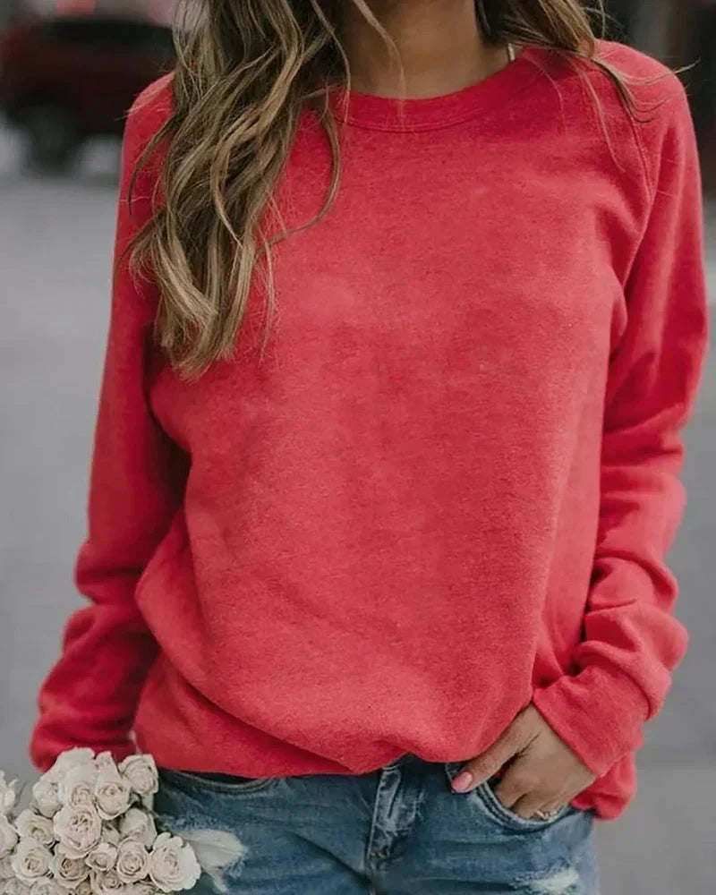 Crewneck sweatshirt for women in red, showing the ribbed neckband and raglan sleeves