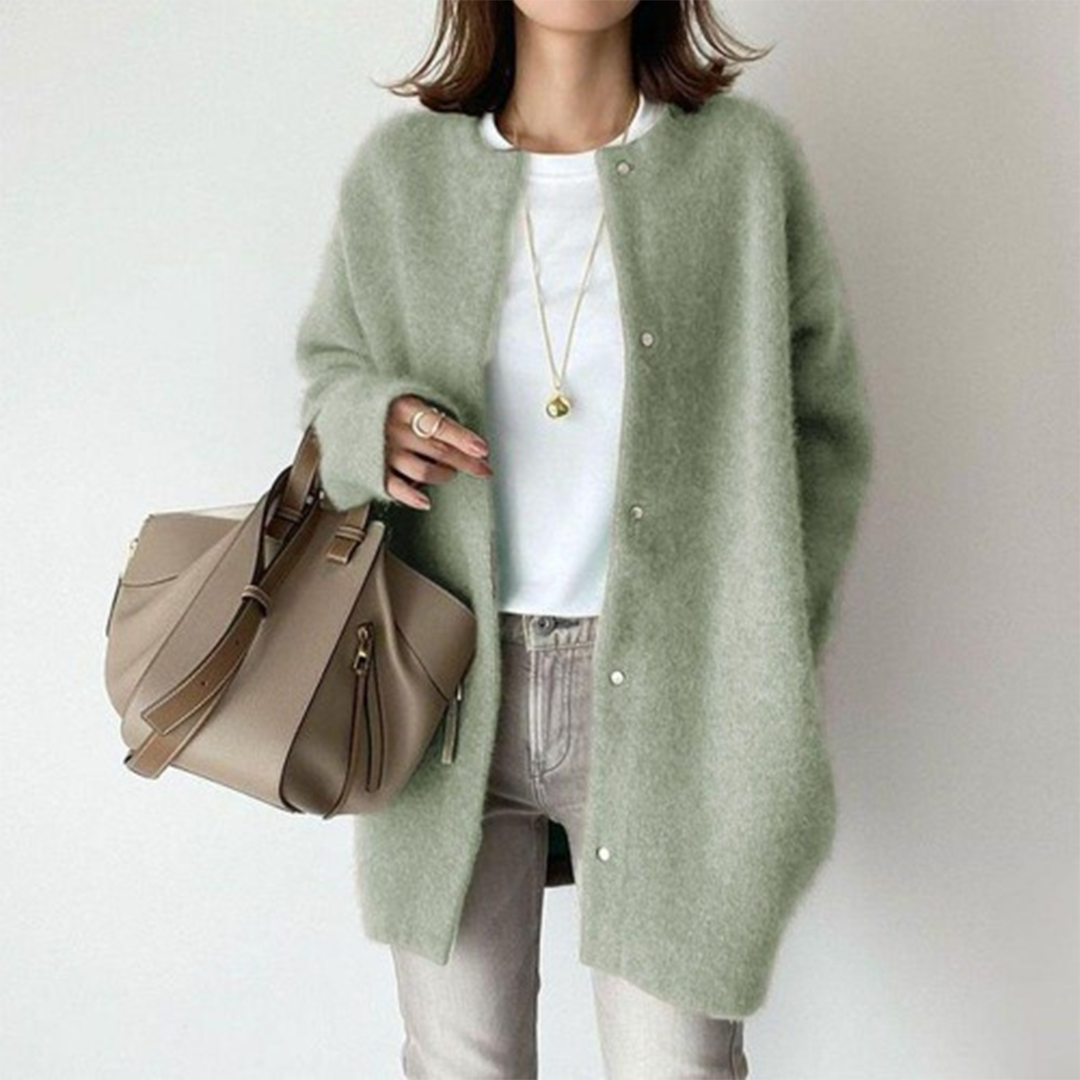 Green cardigan, quiet muted tone against a plain ground