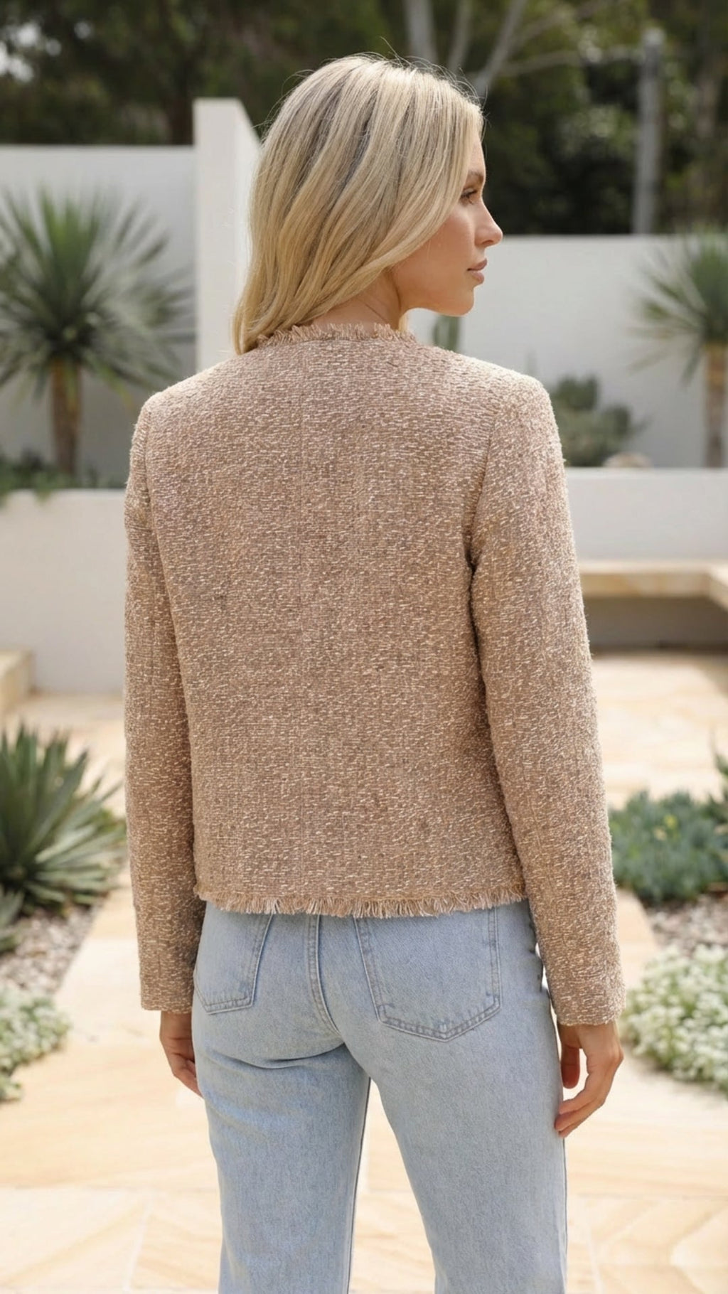 Rear view of the cropped jacket in beige