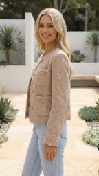 Side profile of the cropped jacket in beige