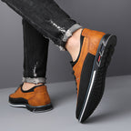 Men's leather dress shoe, single shoe photographed against a plain backdrop