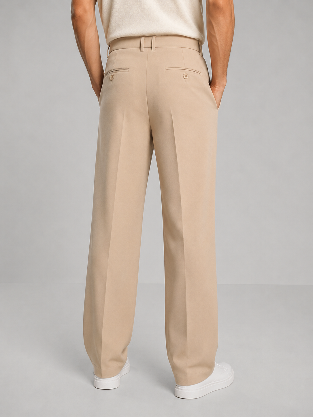 Close-up of the front pleat and structured button waistband on the men's straight leg trousers