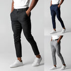 Men's stretch chinos styled with sneakers, seated to show the stretch through the leg