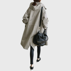 Waterproof trench coat for women worn open over jeans, full-length styling shot