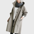 Grey waterproof trench coat for women with the belt tied, front view