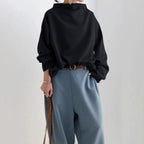 High neck knit top, detail of the long sleeve and cuff