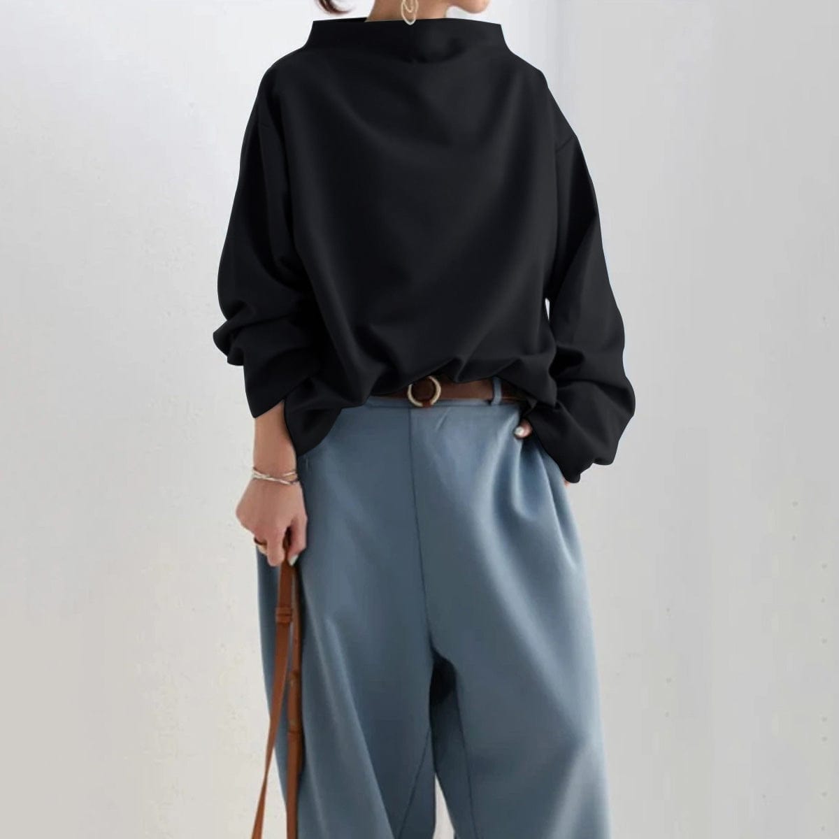 High neck knit top, detail of the long sleeve and cuff