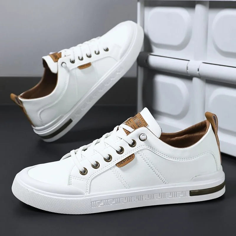 Men's leather sneakers in white and brown, angled view showing the stitched side panels