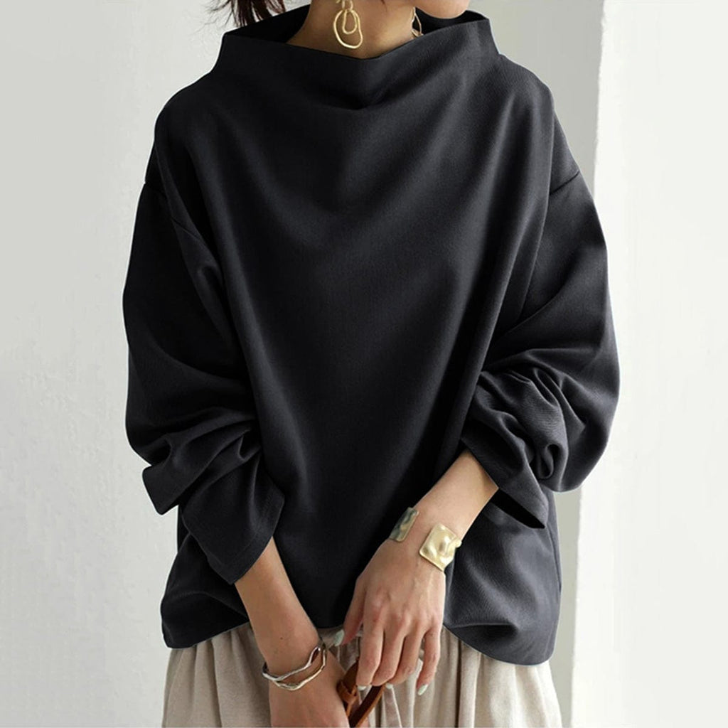 High neck knit top, close-up of the neckline closed at the throat