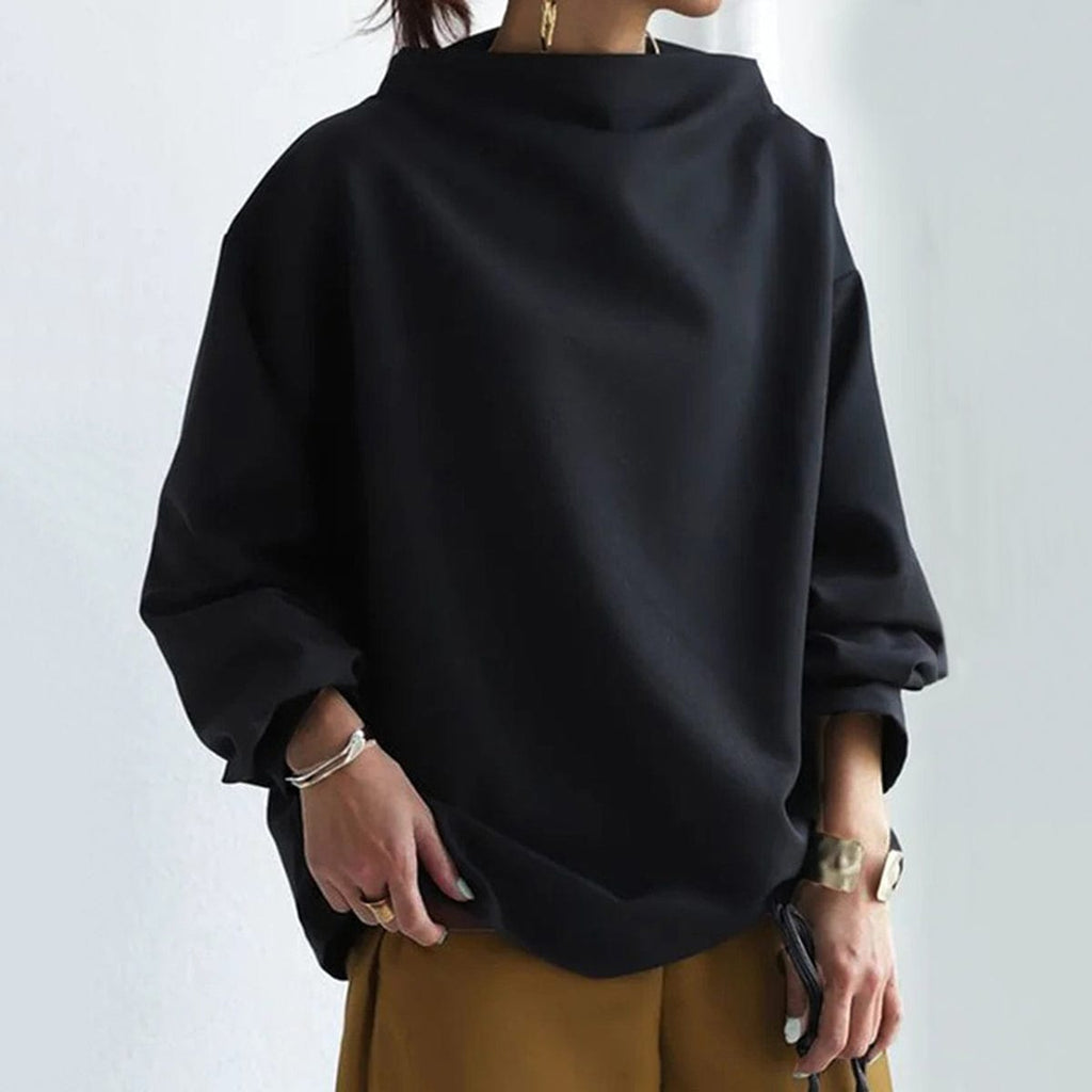 High neck knit top, side view showing the slightly oversized body