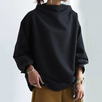 High neck knit top, side view showing the slightly oversized body