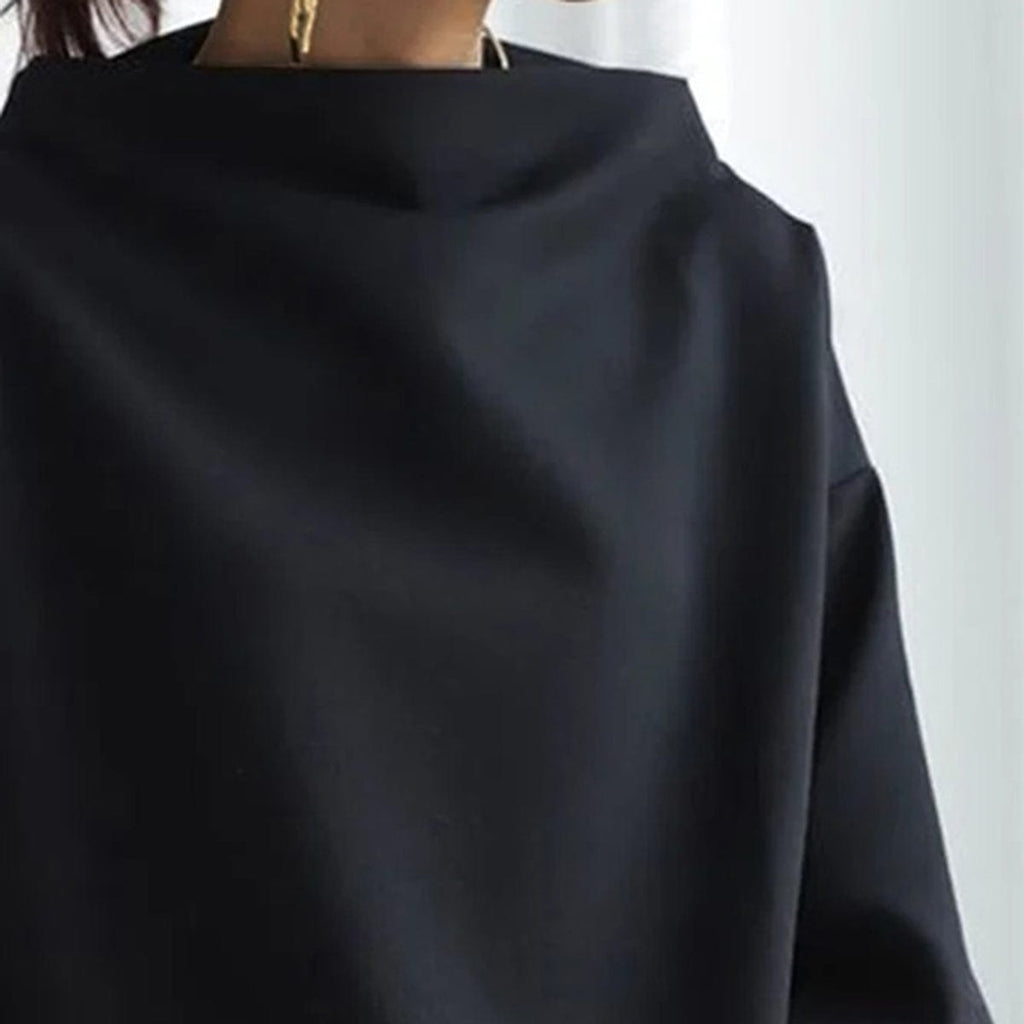High neck knit top worn under a blazer as a layer