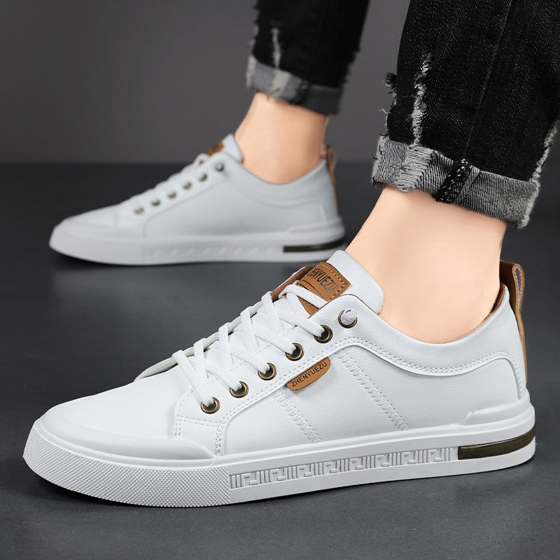 Men's leather sneakers, close-up of the flat rubber sole and lace-up front