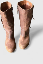 Brown leather boots with the fold-over cuff turned down to ankle height