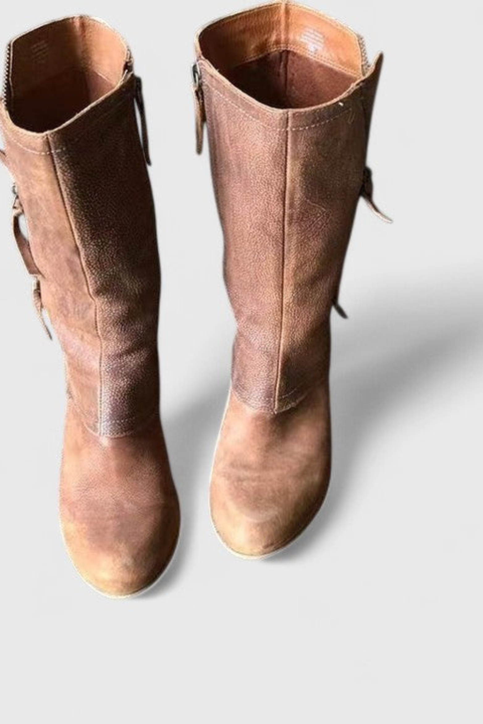 Brown leather boots with the fold-over cuff turned down to ankle height