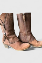 Brown distressed leather block heel ankle boots, side view with the cuff up at mid-calf