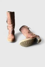 Stacked block heel of the distressed brown leather ankle boots, rear view