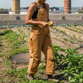 Camel wide leg overalls worn over a knit top