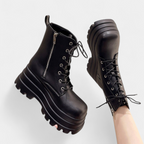 Side zipper closure on the black platform boot