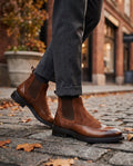 Men's suede brogue Chelsea boot in Brown, shown against a plain studio background