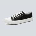 Canvas sneakers for women in black, low top side profile showing the striped rubber outsole