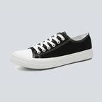 Canvas sneakers for women in black, low top side profile showing the striped rubber outsole