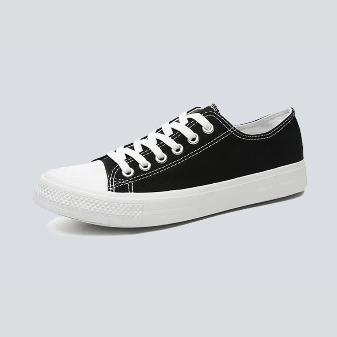 Canvas sneakers for women in black, low top side profile showing the striped rubber outsole
