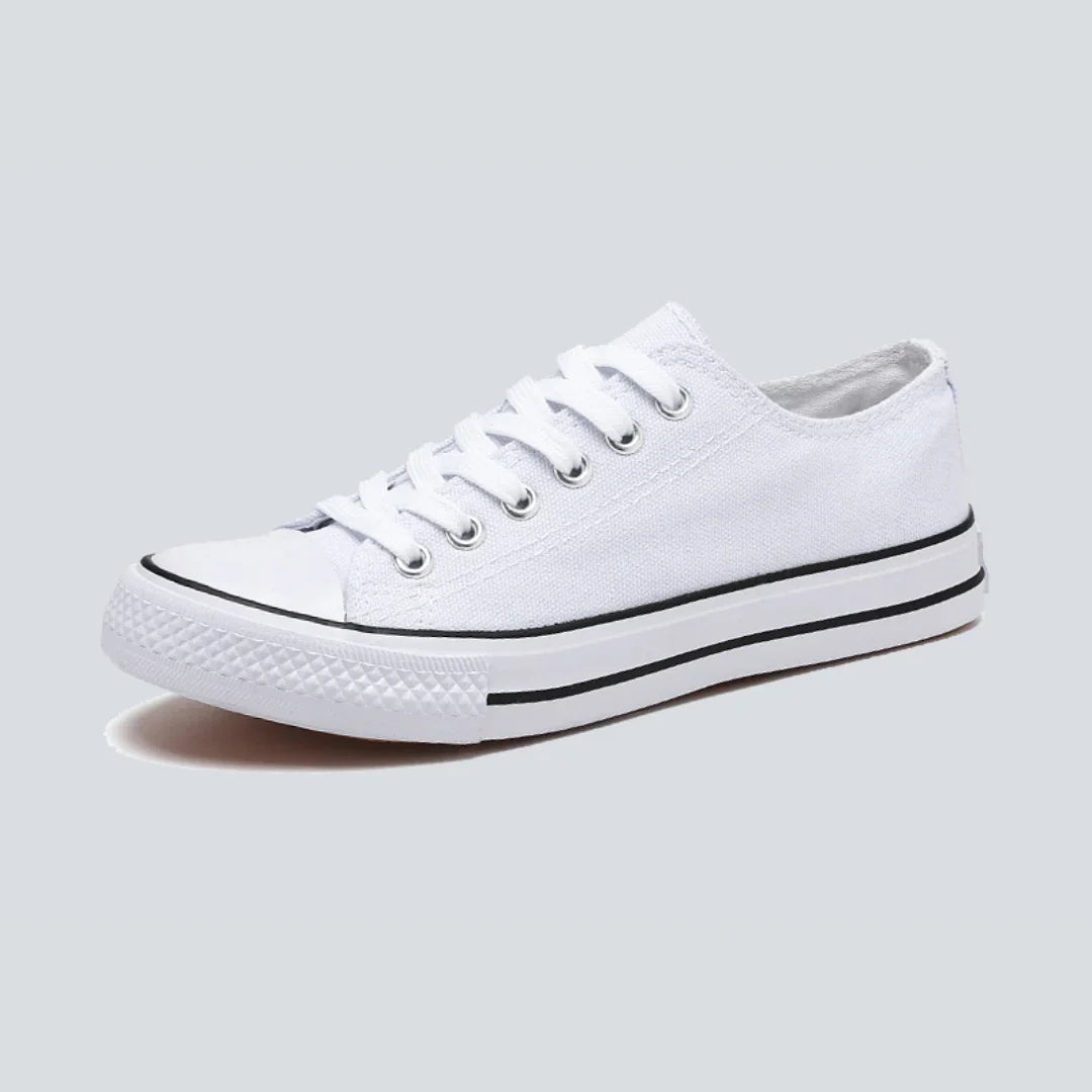 Canvas sneakers for women in white and black, showing the metal eyelets and laces