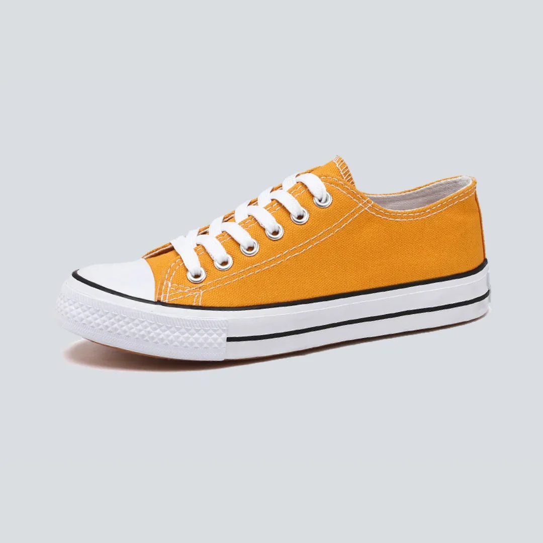 Canvas sneakers for women in orange, showing the lace-up front and white rubber sole