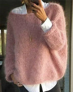 Oversized mohair sweater for women in pink, worn with the wide neckline off the shoulder