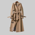 Beige trench coat belted at the waist, falling to midi length