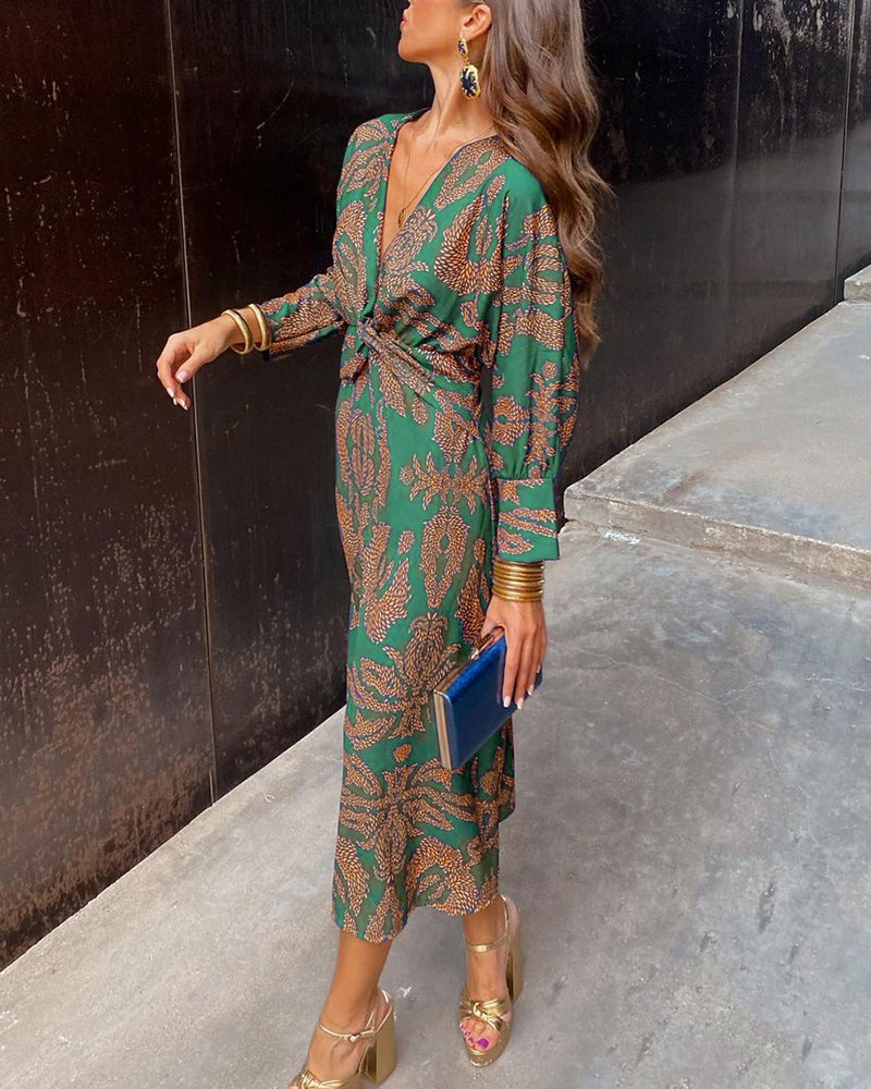 Printed A-line maxi dress for women in green, showing the V-neckline and defined waist