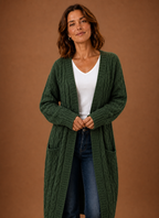 Green hooded cable knit cardigan viewed head-on, open front hanging straight