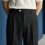 Men's wide leg pleated pants, side view showing the seam pocket and leg drape