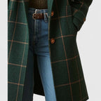 Dark green plaid coat for women, worn closed with the collar turned up